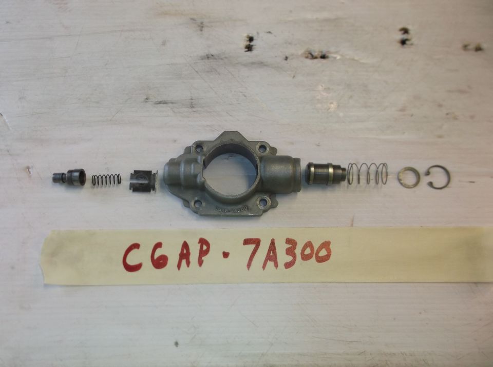 Disassembled oil pump with springs and clip, labeled CGAP-7A300