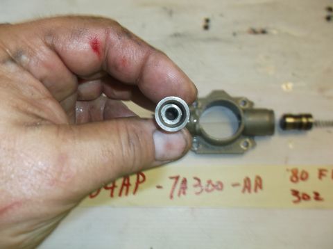 1979 Ford Ranchero - A hand holds a small component next to a disassembled part, with handwritten labels in the background.