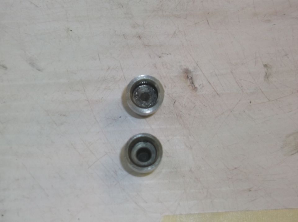 two metal caps with recessed centers