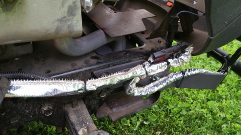 2007 Subaru Impreza - Close-up view of engine bay components, including heat-shielded hoses and wiring, against a grassy background.