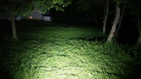 2007 Subaru Impreza - A nighttime scene shows a well-lit lawn with trees and a house in the distance.