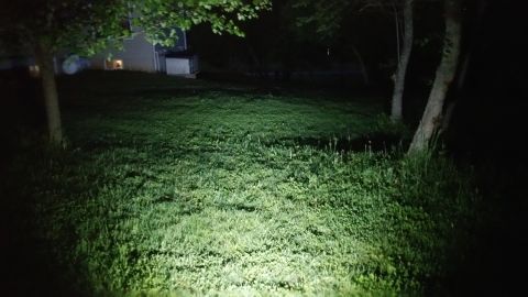 2007 Subaru Impreza - A grassy lawn is brightly lit by a powerful light source at night, with a house and trees in the background. The Supermotors.net logo is vi…