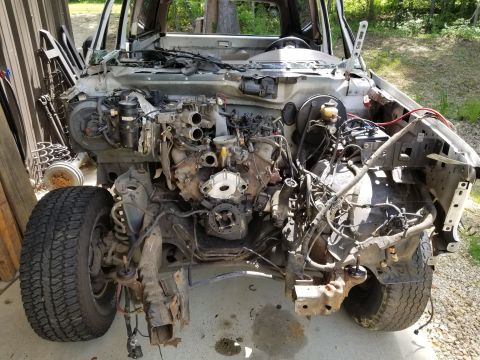 1996 Ford Bronco - In addition to the folded frame & punctured timing cover, the axle is twisted due to the front crossmember being mashed back. The driveshaf…