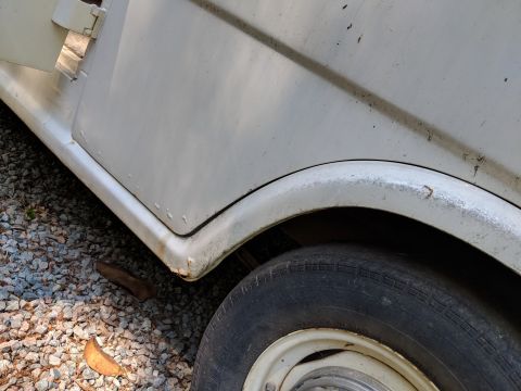 1971 Ford Ranchero - Close-up of the lower side panel and rear wheel well of a white 1971 Ford Ranchero.