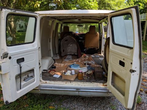 1971 Ford Ranchero - Interior view of a disorganized van with various items scattered inside.