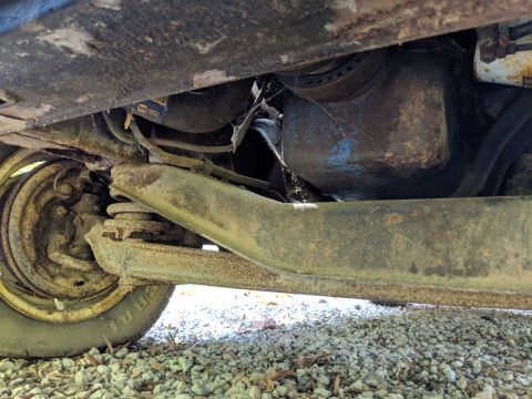 1971 Ford Ranchero - Close-up view of the undercarriage, focusing on the suspension components and the oil pan.