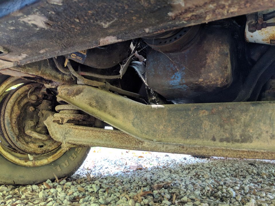 Undercarriage view showing suspension and oil pan