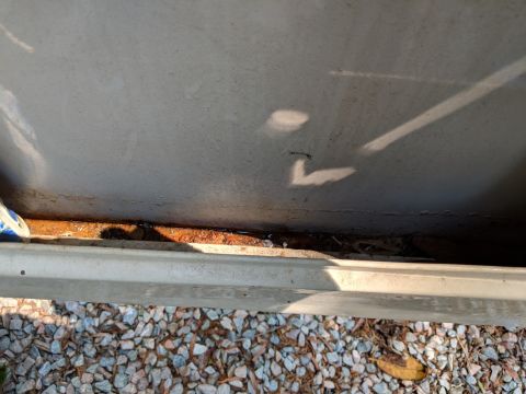 1971 Ford Ranchero - Close-up view of the underside of a vehicle bed, showing rust and debris.