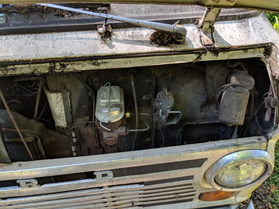 Engine bay with master cylinder and grille showing 'FORD' lettering