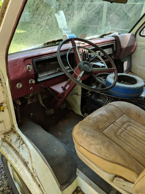 1971 Ford Ranchero - Interior view of a 1971 Ford Econoline van, showing the dashboard, steering wheel, and worn passenger seat.