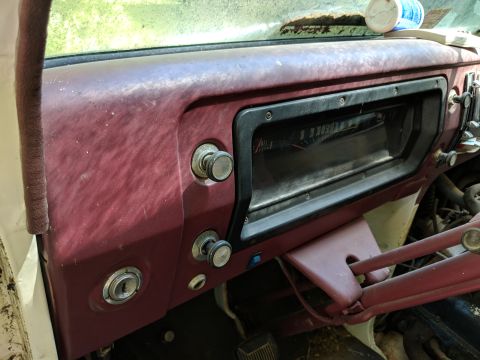 1971 Ford Ranchero - The interior of an older vehicle shows a worn dashboard with various knobs and a clear instrument panel.