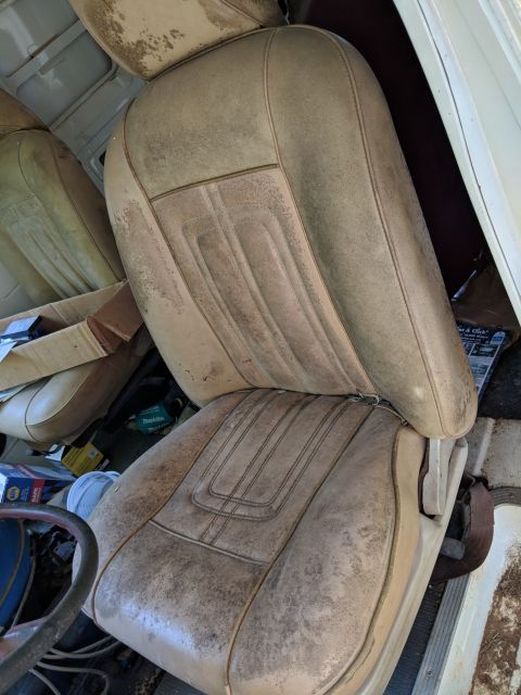 1971 Ford Ranchero - Interior view of worn tan car seats with visible stitching and dirt.