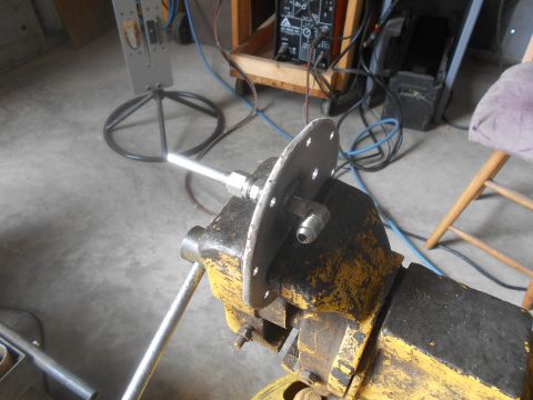 1992 Ford Bronco - A fuel sending unit assembly is secured in a vise, ready for work in a garage setting.