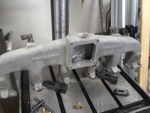 1985 Ford Bronco - Intake manifold with 'CLIFFORD' casting, secured on a drill press for modification.