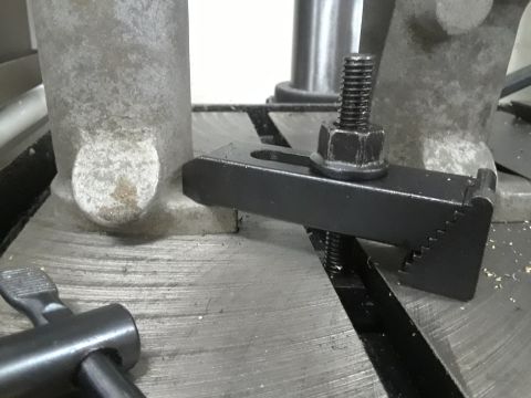 1985 Ford Bronco - Close-up of a T-slot clamp used in machinery, with a bolt and nut.