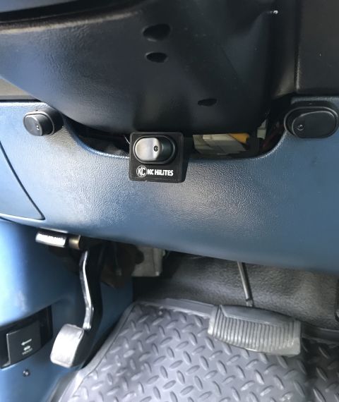 1995 Ford Bronco - Close-up of the interior showing a KC HiLiTES switch and the brake and gas pedals.