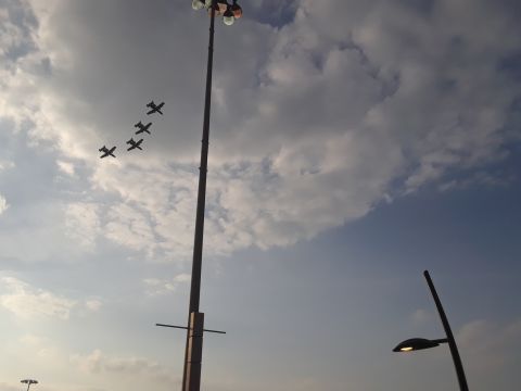 1994 Ford Bronco - Jet aircraft formation flying in the sky, with a tall light pole and street lamp visible.