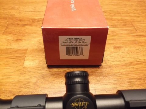 1995 Mercury Grand Marquis - A Swift Premier rifle scope and its packaging are displayed on a wooden surface.