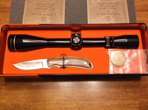 1995 Mercury Grand Marquis - A Leupold scope, knife, and coin are displayed in a fitted orange case with accompanying documentation.