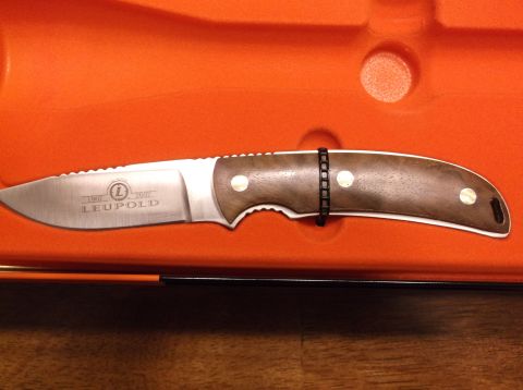 1995 Mercury Grand Marquis - A Leupold knife with a wooden handle and serrated blade is displayed in its orange case.