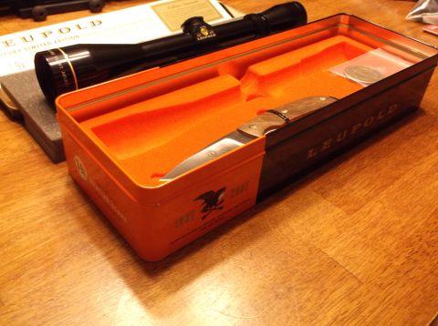 1995 Mercury Grand Marquis - A Leupold knife and scope set is displayed in its orange and black presentation case on a wooden surface.