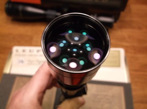 1995 Mercury Grand Marquis - Kaleidoscope view through a scope lens, with a box and another scope in the background.