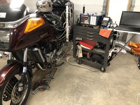 1983 Yamaha Venture - A 1983 Yamaha Venture motorcycle is connected to diagnostic tools and a laptop in a garage setting.