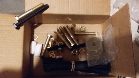 2000 Pontiac Grand Prix - A collection of hardware, including bolts, nuts, washers, and zip ties, is neatly organized within a cardboard box.