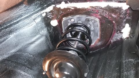 2000 Pontiac Grand Prix - Front strut assembly with coil spring and mount visible in vehicle chassis.