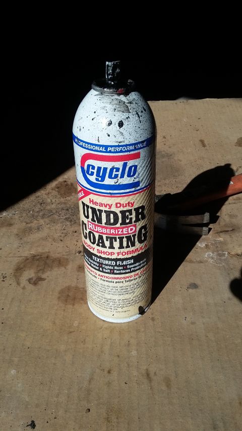 2000 Pontiac Grand Prix - A can of undercoating sits on a concrete surface, casting a shadow.