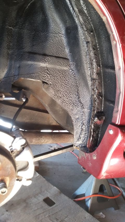 2000 Pontiac Grand Prix - Close-up of a vehicle's undercarriage, showing the wheel well and suspension components.