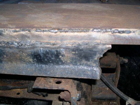 1986 Ford Bronco - Close-up of rusted metal frame showing welds and damage.