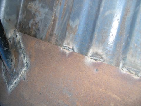 1986 Ford Bronco - This image shows rusted metal with recent welds, likely part of a vehicle repair.