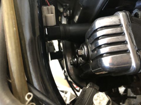 1983 Yamaha Venture - A close-up view of a motorcycle's engine area, focusing on a chrome component and electrical connections.