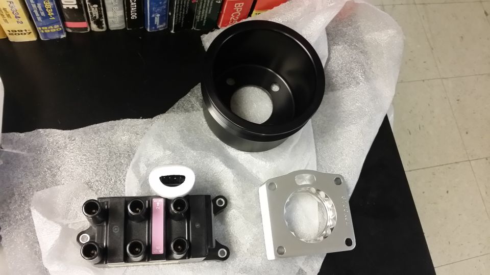 Screamin Demon coil pack, ASP underdrive pulley and throttle body spacer (which was a failed attempt at an idea before it even touched the truck.)