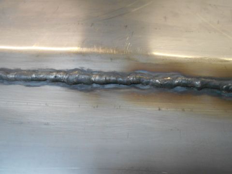 1992 Ford Bronco - Close-up of a metal surface showing a prominent weld seam with discoloration.