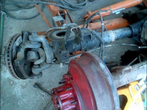 1978 Ford Bronco - Close-up of a vehicle's front axle assembly, showing brake components and suspension parts.