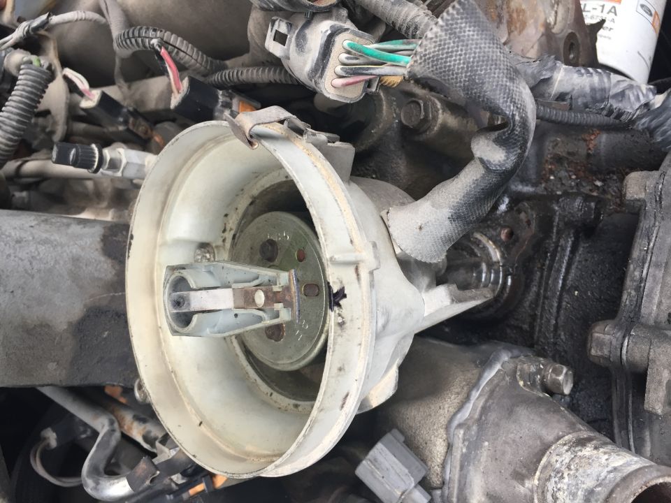 Close-up of a vehicle's engine distributor cap and rotor assembly