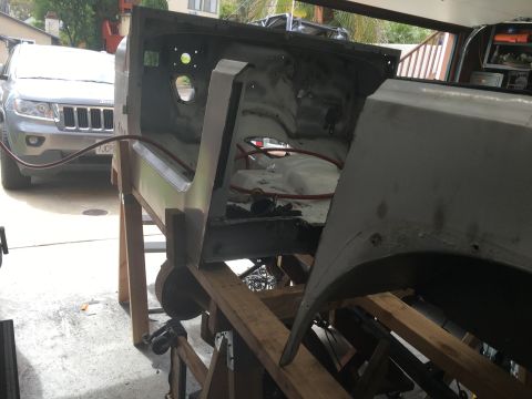 1992 Jeep Wrangler - The body of a Jeep Wrangler is shown on a stand, likely for bodywork or restoration.