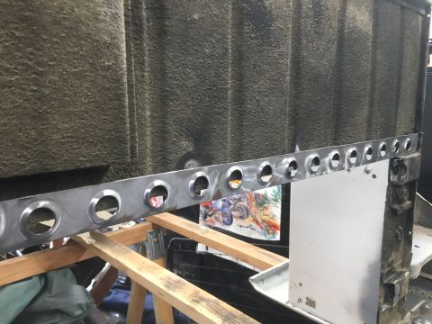 1992 Jeep Wrangler - A metal strip with evenly spaced holes is shown, attached to a vehicle's body panel during repair work.