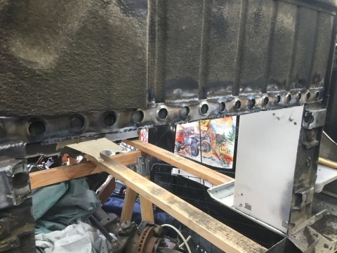 1992 Jeep Wrangler - Close-up view of a vehicle's frame undergoing repair, highlighting welded sections and structural supports.
