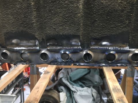 1992 Jeep Wrangler - Frame repair work showing newly welded sections with multiple circular openings.