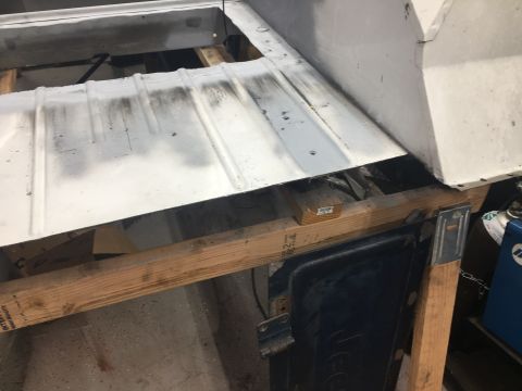 1992 Jeep Wrangler - Close-up of a vehicle's floor pan undergoing repair work, supported by wooden beams.