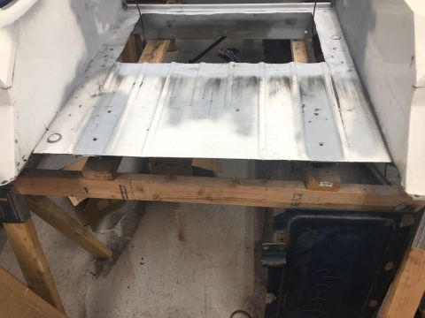1992 Jeep Wrangler - The underside of a vehicle is visible, undergoing repairs or restoration.