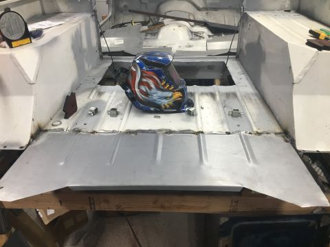 1992 Jeep Wrangler - Vehicle interior showing floor panels and a welding mask during a repair project.