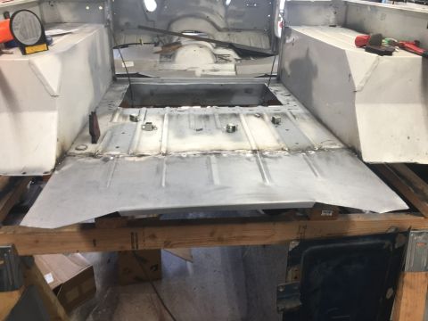 1992 Jeep Wrangler - The interior of a vehicle is shown with its floor pan removed and replaced, indicating restoration work.