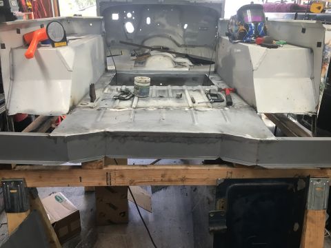 1992 Jeep Wrangler - Jeep CJ body tub in restoration, with floor pan and inner fenders exposed. Welding gear is present.