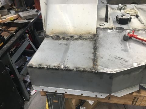 1992 Jeep Wrangler - A close-up view of a metal body panel undergoing repair with visible welding marks.