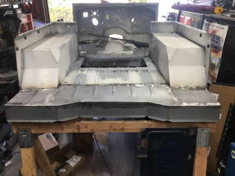 1992 Jeep Wrangler - The rear tub of a Jeep is shown during bodywork, with new metal panels being welded and fitted.