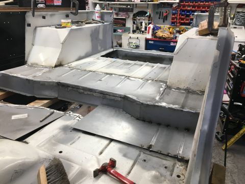 1992 Jeep Wrangler - The interior of a Jeep tub is shown with new metal floor panels being welded and fitted during a restoration project.
